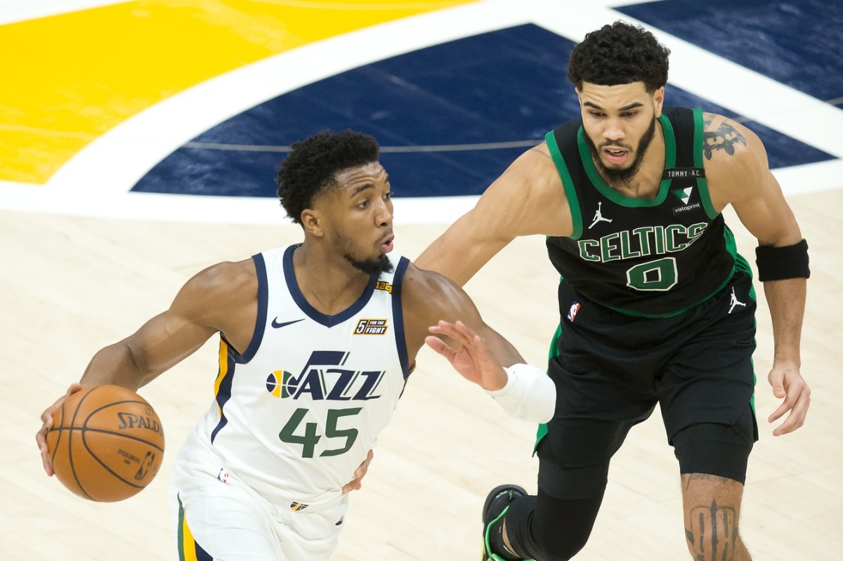 Donovan Mitchell (45) makes a move to the basket past Jayson Tatum (0)